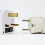 two white power adapters on white background